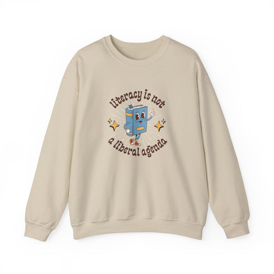 Tan unisex crewneck sweatshirt with retro book character graphic and "literacy is not a liberal agenda" brown text
