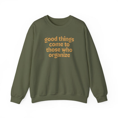 Military green unisex crewneck sweatshirt with 'good things come to those who organize' gold text