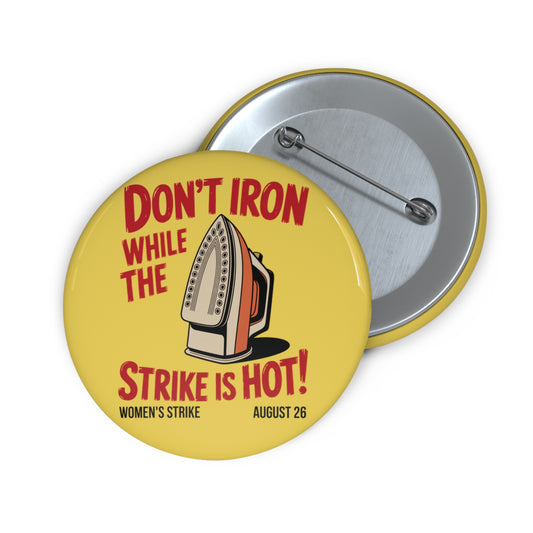 Yellow pin button with vintage iron graphic and text 'Don't Iron While the Strike is Hot!' red text