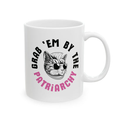 White ceramic 11 oz coffee or tea mug with punk rock cat graphic and black and pink text "grab 'em by the patriarchy"