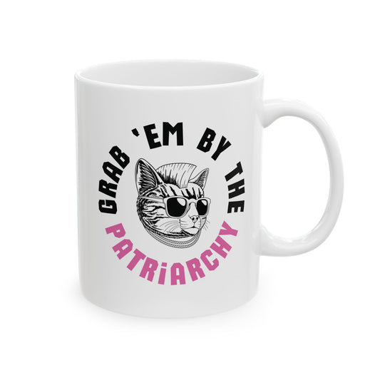 White ceramic 11 oz coffee or tea mug with punk rock cat graphic and black and pink text "grab 'em by the patriarchy"