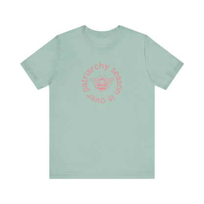 Sage green unisex t-shirt with 'Patriarchy season is over' dark pink text and bee graphic