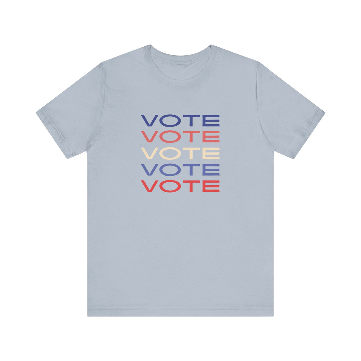 A light blue short-sleeve crewneck t-shirt featuring a stacked graphic print of the word 'VOTE' in blue, red, and cream on the chest.