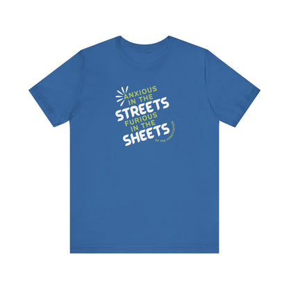 Blue t-shirt with white and green text "anxious in the streets, furious in the sheets (of the constitution)"