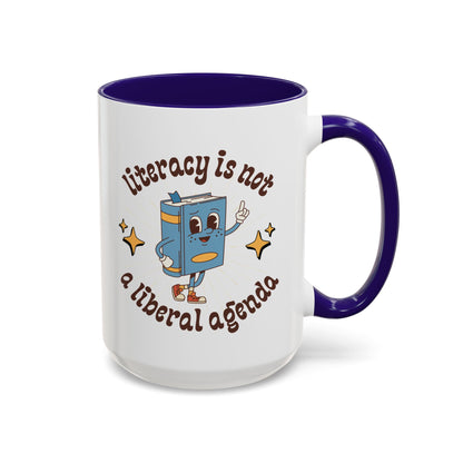 White ceramic 15 oz coffee or tea mug with blue interior and handle with cartoon book character graphic and text 'literacy is not a liberal agenda' 