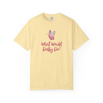 A pale yellow short-sleeve t-shirt with a pink butterfly graphic and the text 'What Would Dolly Do!' printed on the chest, displayed against a solid white background.