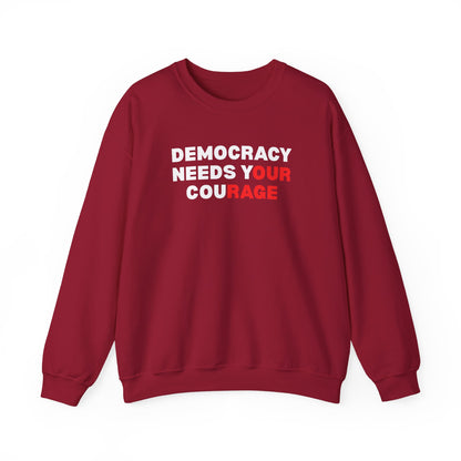 Red unisex crewneck sweatshirt with 'Democracy Needs Your Courage' white and red text