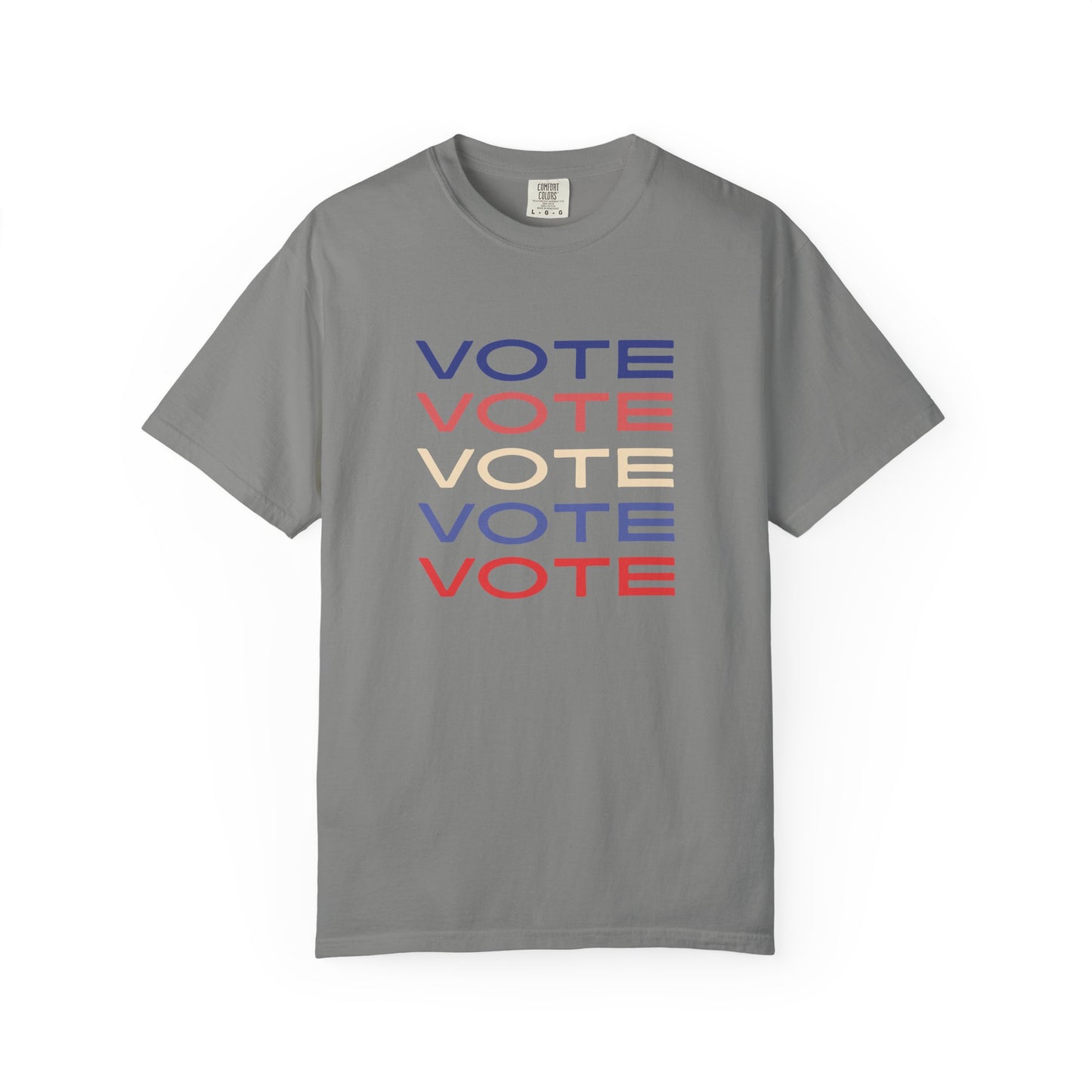 A gray short-sleeve crewneck t-shirt featuring a stacked graphic print of the word 'VOTE' in blue, red, and beige, displayed on a clean white background.
