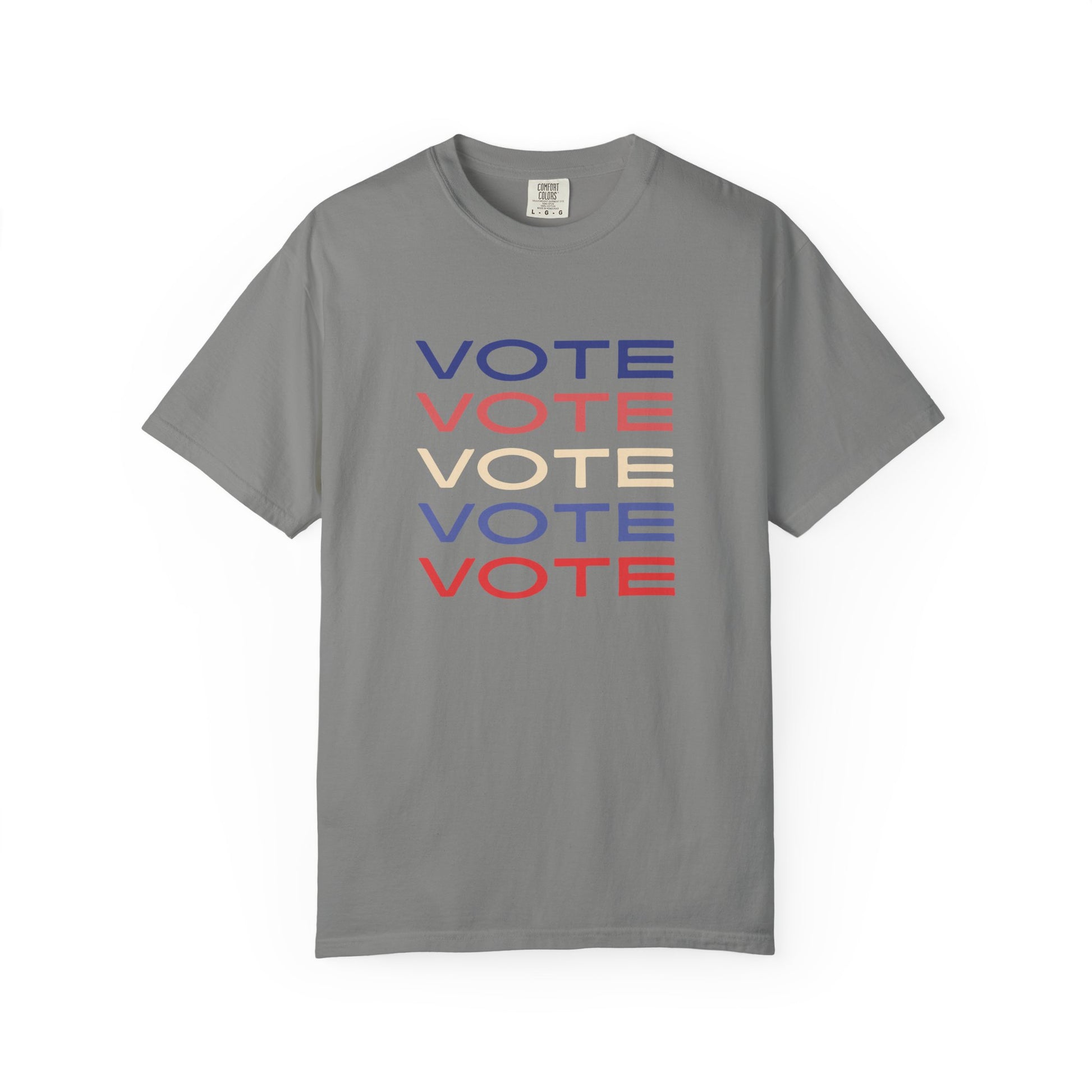 A gray short-sleeve crewneck t-shirt featuring a stacked graphic print of the word 'VOTE' in blue, red, and beige, displayed on a clean white background.