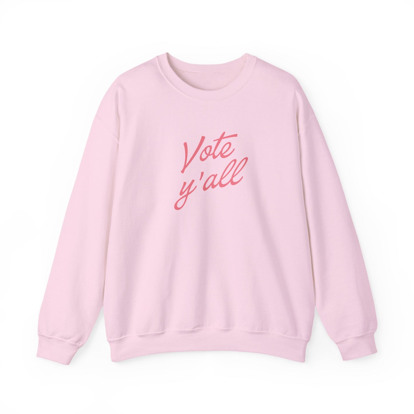 A light pink crewneck sweatshirt with the phrase 'Vote y'all' printed in a pink cursive font across the chest, displayed on a clean white background.