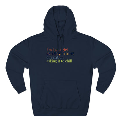 Navy blue hoodie with colorful text "i'm just a girl standing in front of a nation asking it to chill"