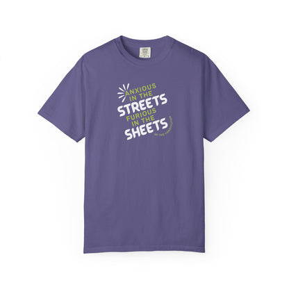 Purple t-shirt with white and lime green text "anxious in the streets furious in the sheets (of the constitution)"