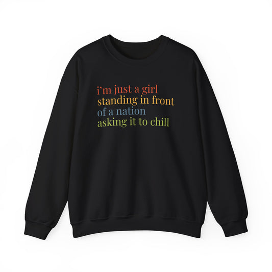 Black Unisex crewneck sweatshirt with colorful “I'm just a girl, standing in front of a nation, asking it to chill” text
