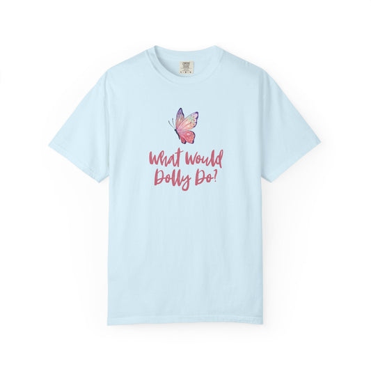 A light blue short-sleeve t-shirt with a graphic of a pink and purple butterfly above the pink cursive text 'What Would Dolly Do!' on the chest, displayed on a clean white background.