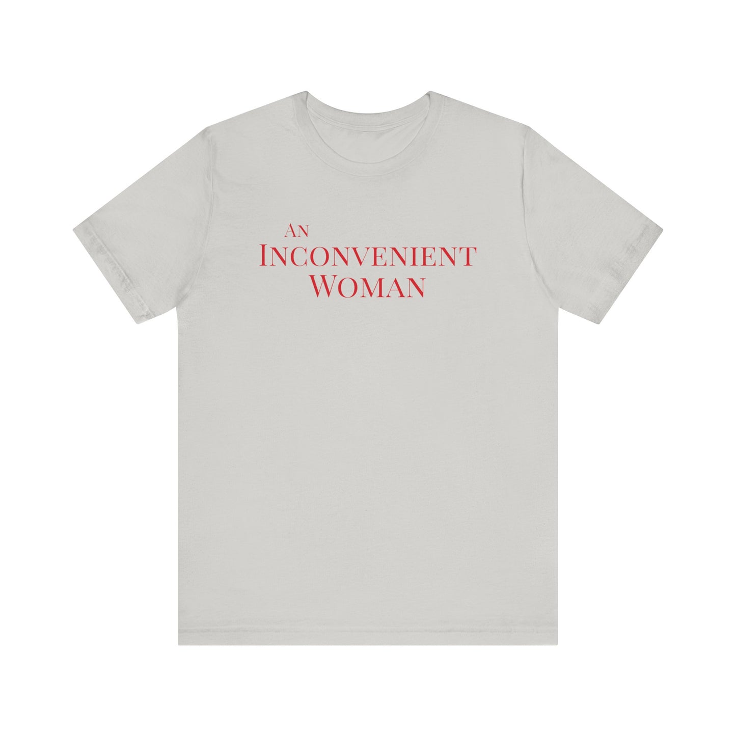Light gray t-shirt with red text "An Inconvenient Woman"