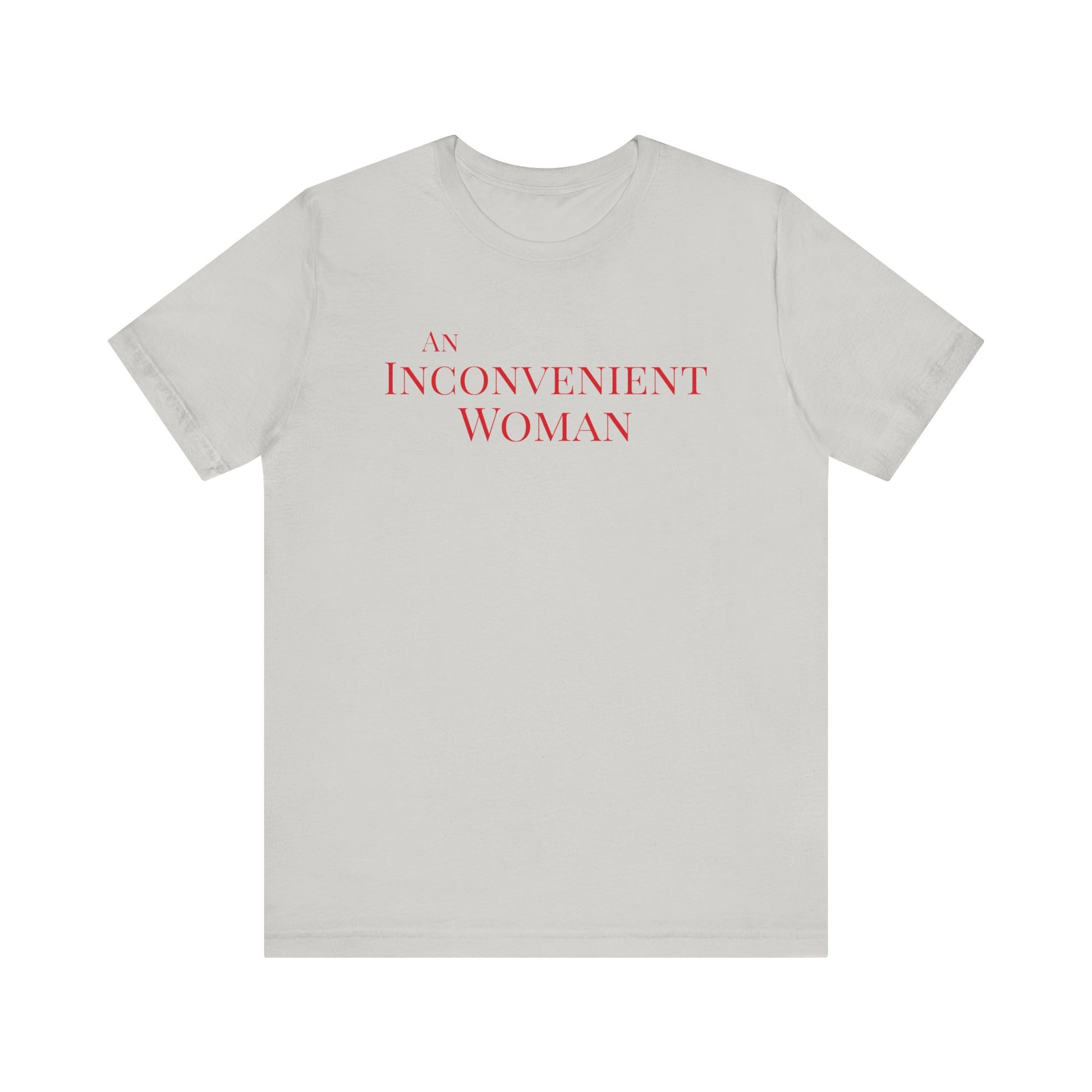 Light gray t-shirt with red text "An Inconvenient Woman"