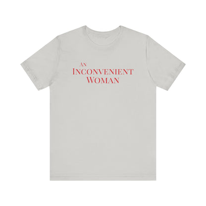 Light gray t-shirt with red text "An Inconvenient Woman"