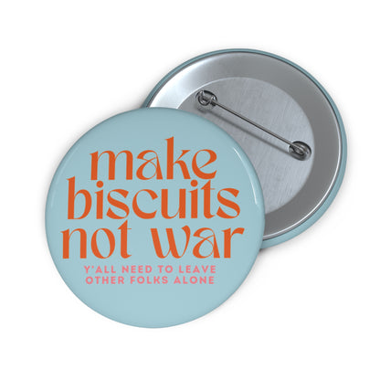 Light blue button with 'make biscuits not war' orange text and smaller pink text "y'all need to leave other folks alone"