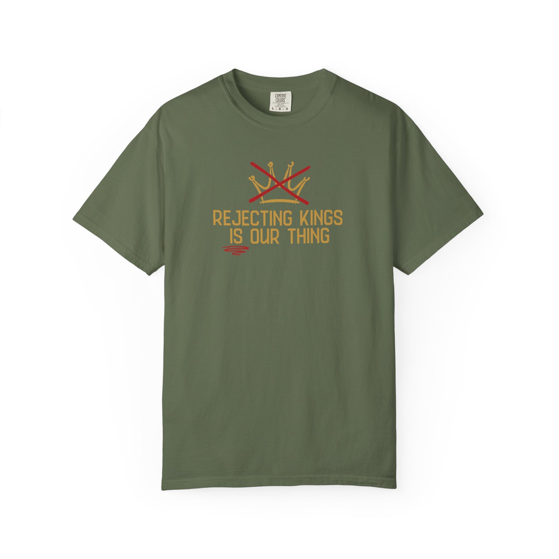 Military green t-shirt with a gold sketch graphic of a crown with a red X over it and gold text "REJECTING KINGS IS OUR THING"