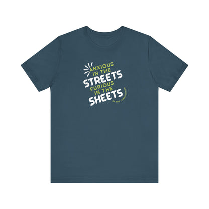 Blue t-shirt with white and green text "anxious in the streets, furious in the sheets (of the constitution)"