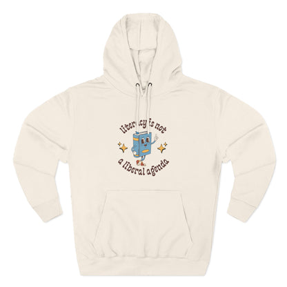 Beige hoodie with retro book character graphic and brown text "literacy is not a liberal agenda"