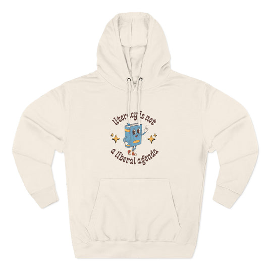 Beige hoodie with retro book character graphic and brown text "literacy is not a liberal agenda"