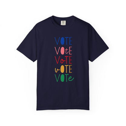 A navy blue short-sleeve t-shirt with a vertical graphic spelling 'VOTE' in alternating blue, pink, red, yellow, and green colors, displayed on a clean white background.