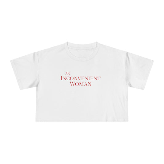 White t-shirt with 'An Inconvenient Woman' text in red 