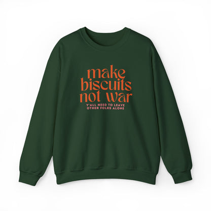 Dark green sweatshirt with orange text "make biscuits not war" and smaller pink text underneath "y'all need to leave other folks alone"