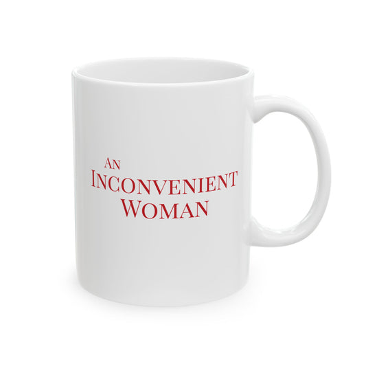 White 11 oz mug with red text 'AN INCONVENIENT WOMAN' 