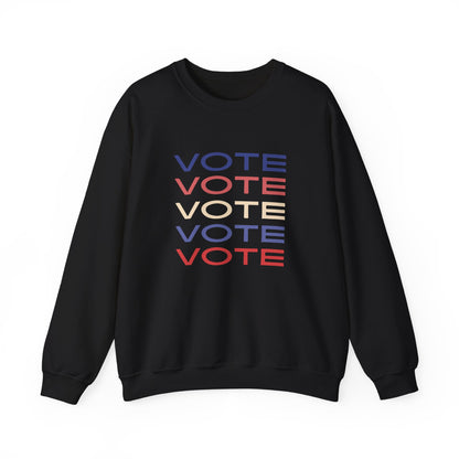 A black crewneck sweatshirt featuring a stacked graphic print of the word 'VOTE' in blue, red, and beige, displayed on a clean white background.