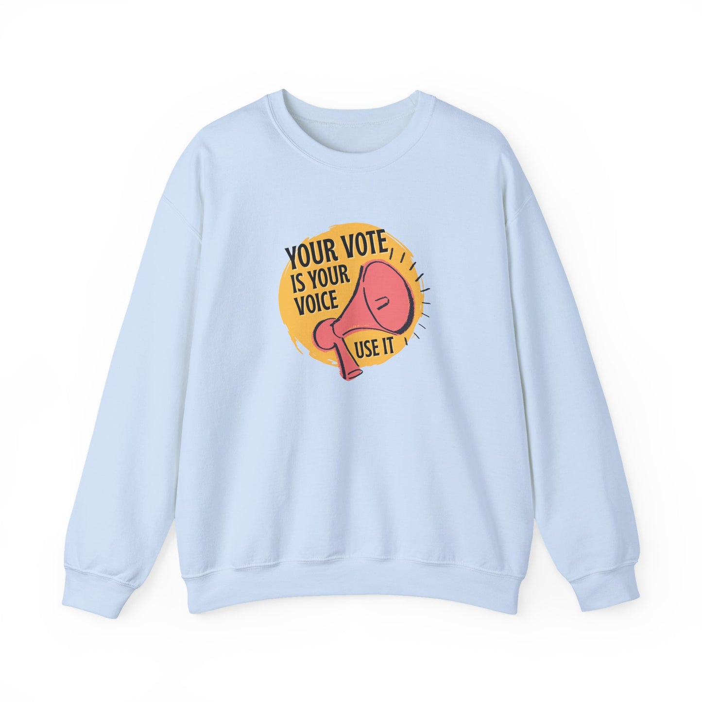 Light blue sweatshirt with a coral megaphone graphic against a bright yellow circle and black text "your vote is your voice, use it"