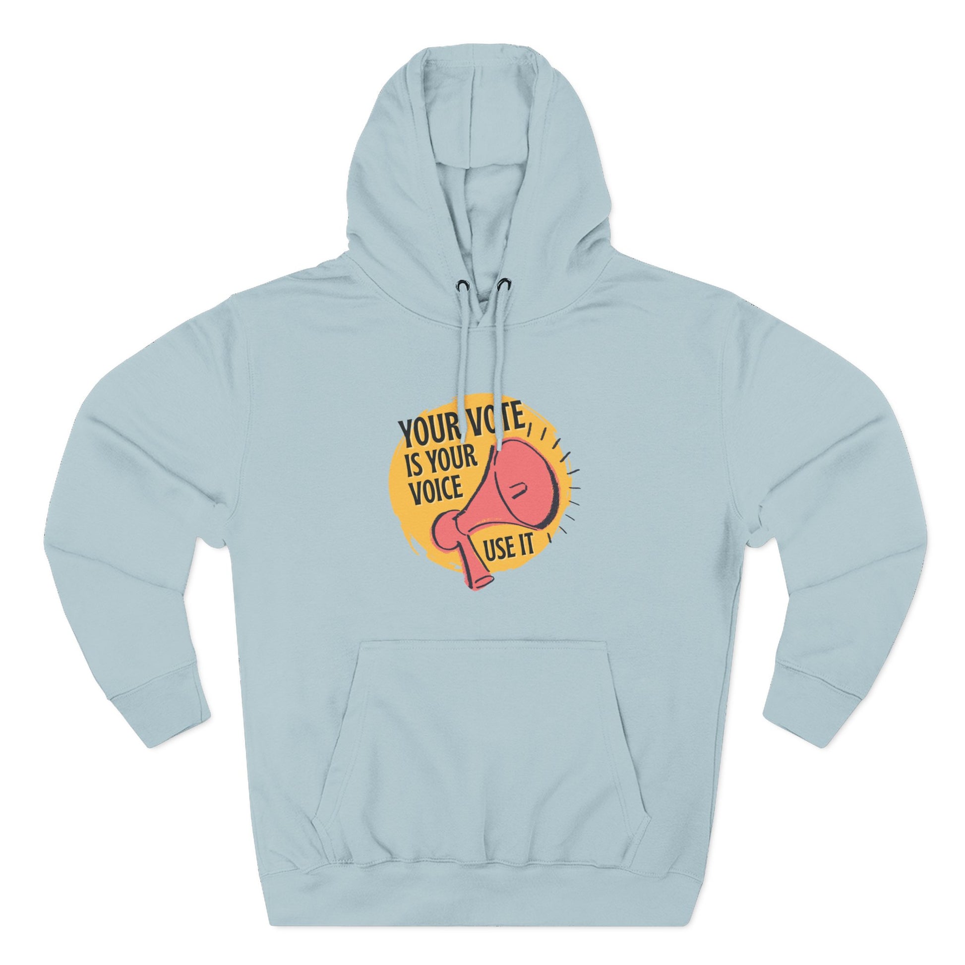 Light blue hoodie with coral megaphone graphic against a bright yellow circle and black text "your vote is your voice, use it"