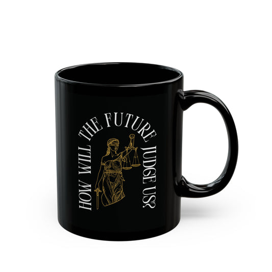 Black ceramic 11 oz coffee or tea mug with a design of Lady Justice and white text 'How will the future judge us?' 