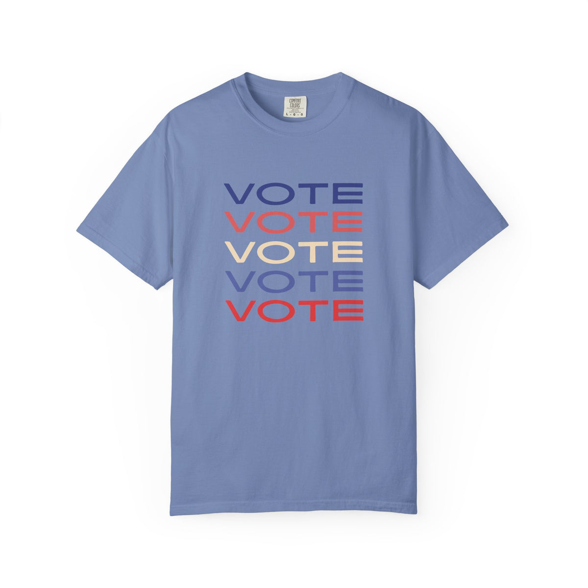 A blue short-sleeve crewneck t-shirt featuring a stacked graphic print of the word 'VOTE' in blue, red, and beige, displayed on a clean white background.