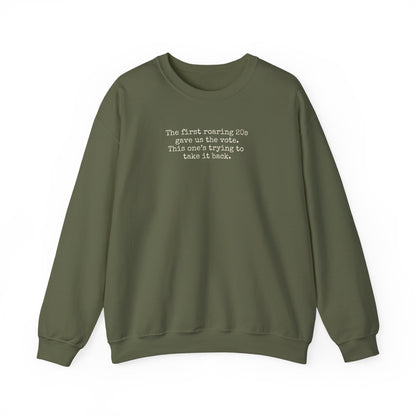 Military green unisex crewneck sweatshirt with "the first roaring 20s gave us the vote. This one's trying to take it back" cream text