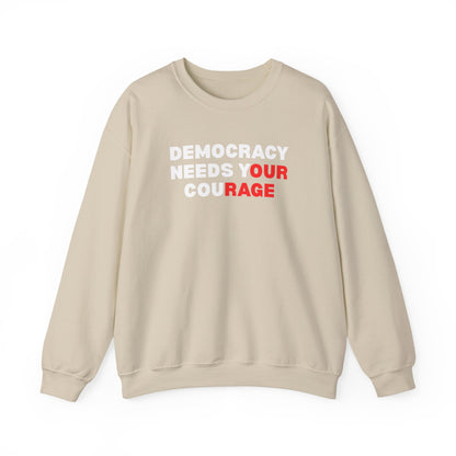 Tan unisex crewneck sweatshirt with 'Democracy Needs Your Courage' white and red text