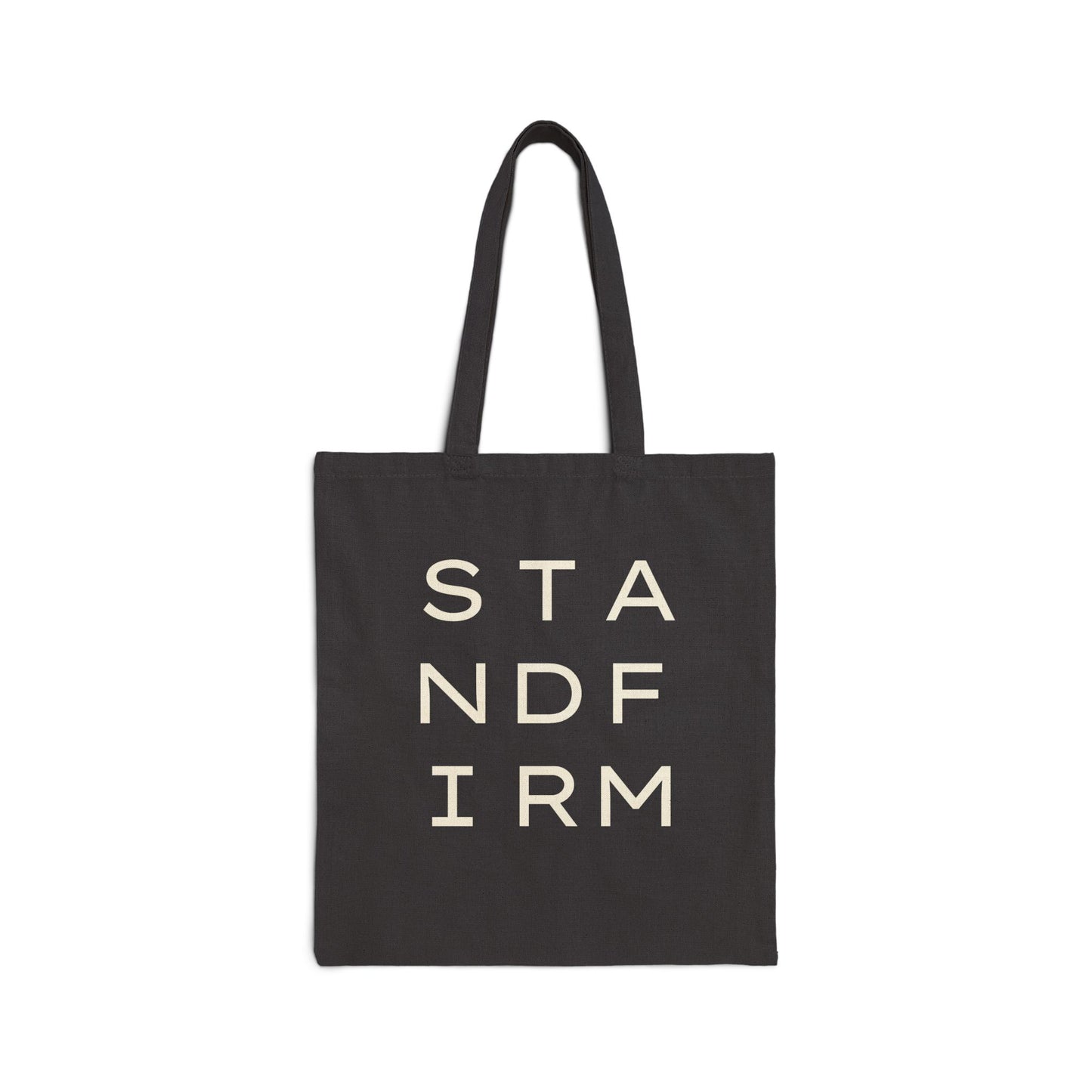 Black canvas tote bag with 'STAND FIRM' cream text