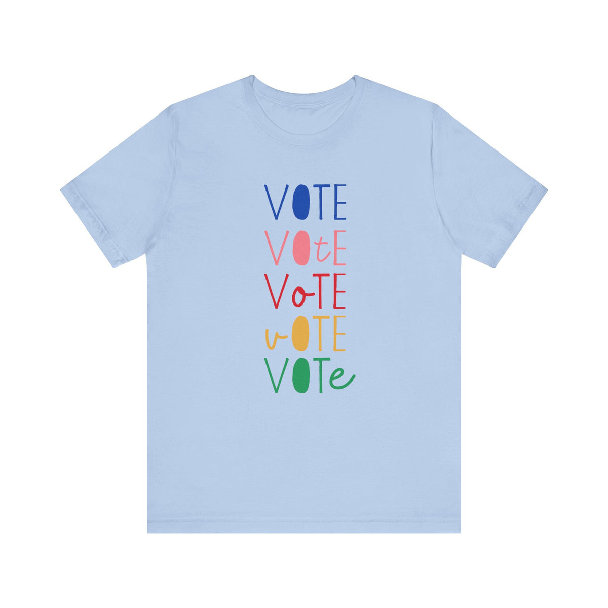 A light blue short-sleeve t-shirt with a vertical graphic on the chest spelling 'VOTE' in alternating bright colors (blue, pink, red, yellow, green) with oval letterforms, shown on a plain white background.