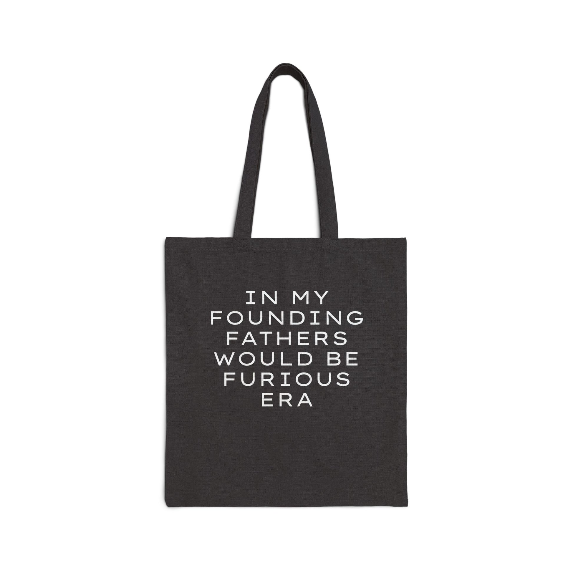 Black canvas tote bag with “In my founding fathers would be furious era” text in white
