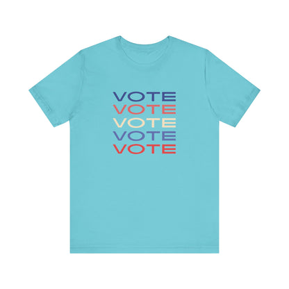 A turquoise short-sleeve crewneck t-shirt featuring a stacked graphic print of the word 'VOTE' in blue, red, and cream on the chest.