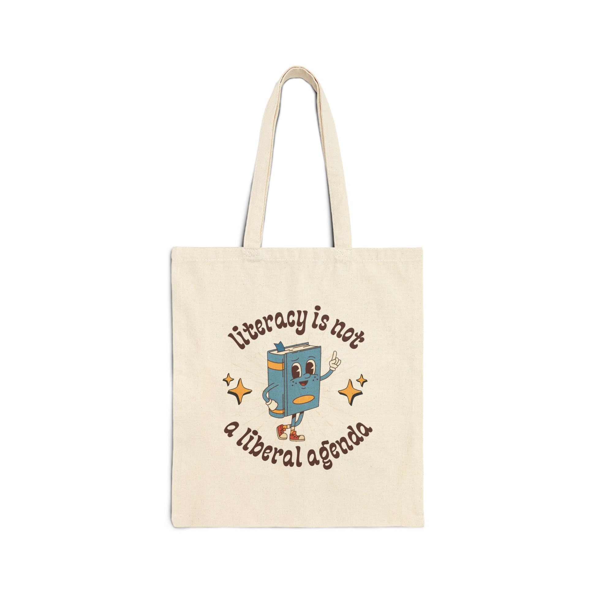 Tote bag with cartoon book character and text 'Literacy is not a liberal agenda' on a white background