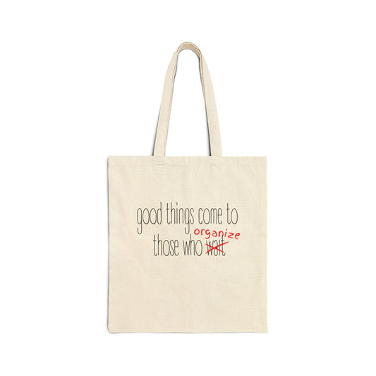 Beige canvas tote bag with "good things come to those who wait (organize)" black and red text
