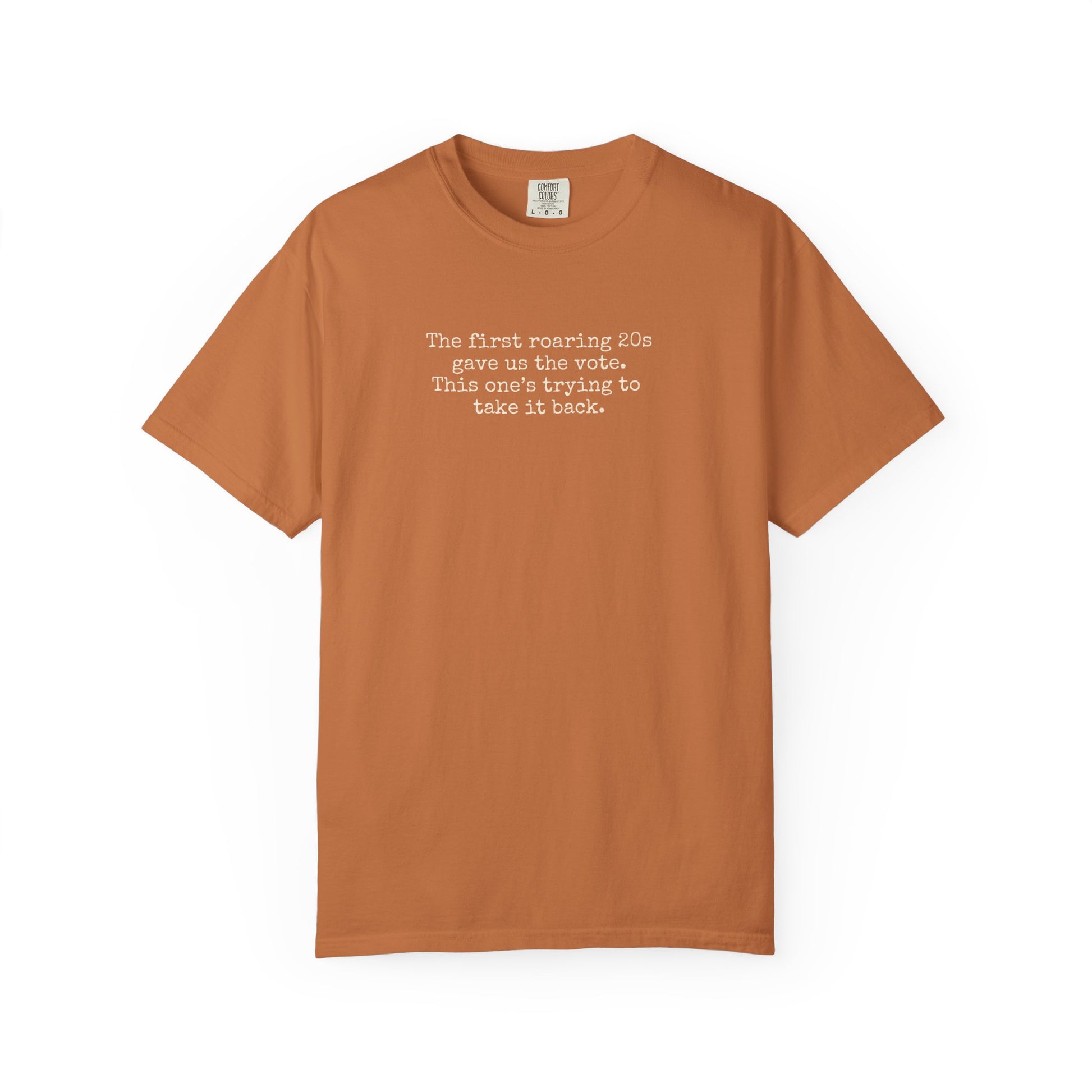 Orange unisex Comfort Colors t-shirt  with "the first roaring 20s gave us the vote. this one's trying to take it back" cream text.