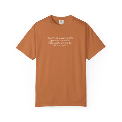 Orange unisex Comfort Colors t-shirt  with "the first roaring 20s gave us the vote. this one's trying to take it back" cream text.