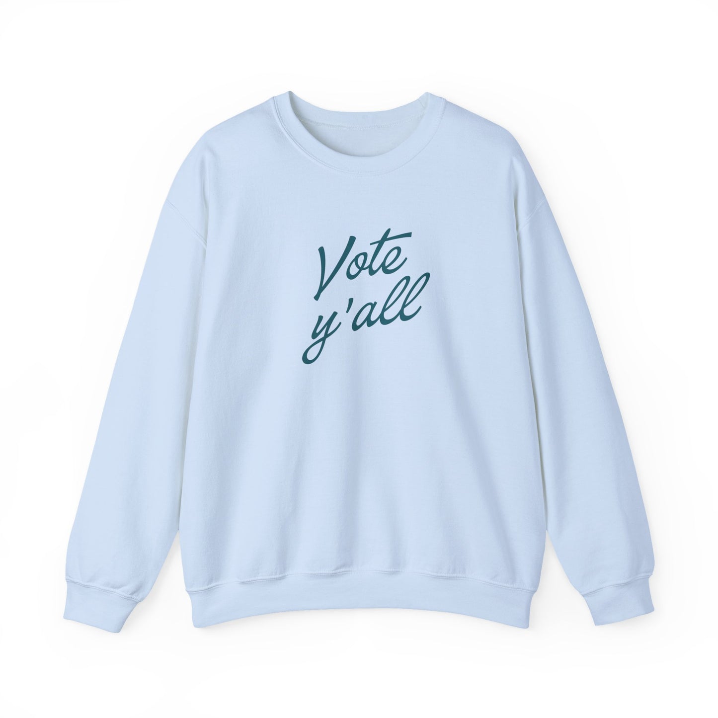 A light blue crewneck sweatshirt with the words 'Vote y'all' printed in a dark blue cursive font on the chest