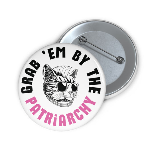 White button with punk rock cat and black and pink text "grab 'em by the patriarchy"