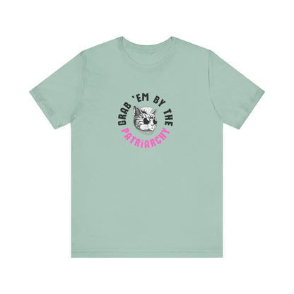 Light green t-shirt with punk rock graphic design and black and hot pink text "grab 'em by the patriarchy"