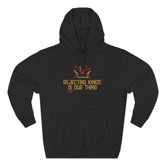 Black hoodie with gold sketch graphic of a crown with a red X over it and gold text "REJECTING KINGS IS OUR THING"