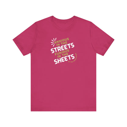 Hot pink t-shirt with white and green text "anxious in the streets, furious in the sheets (of the constitution)"